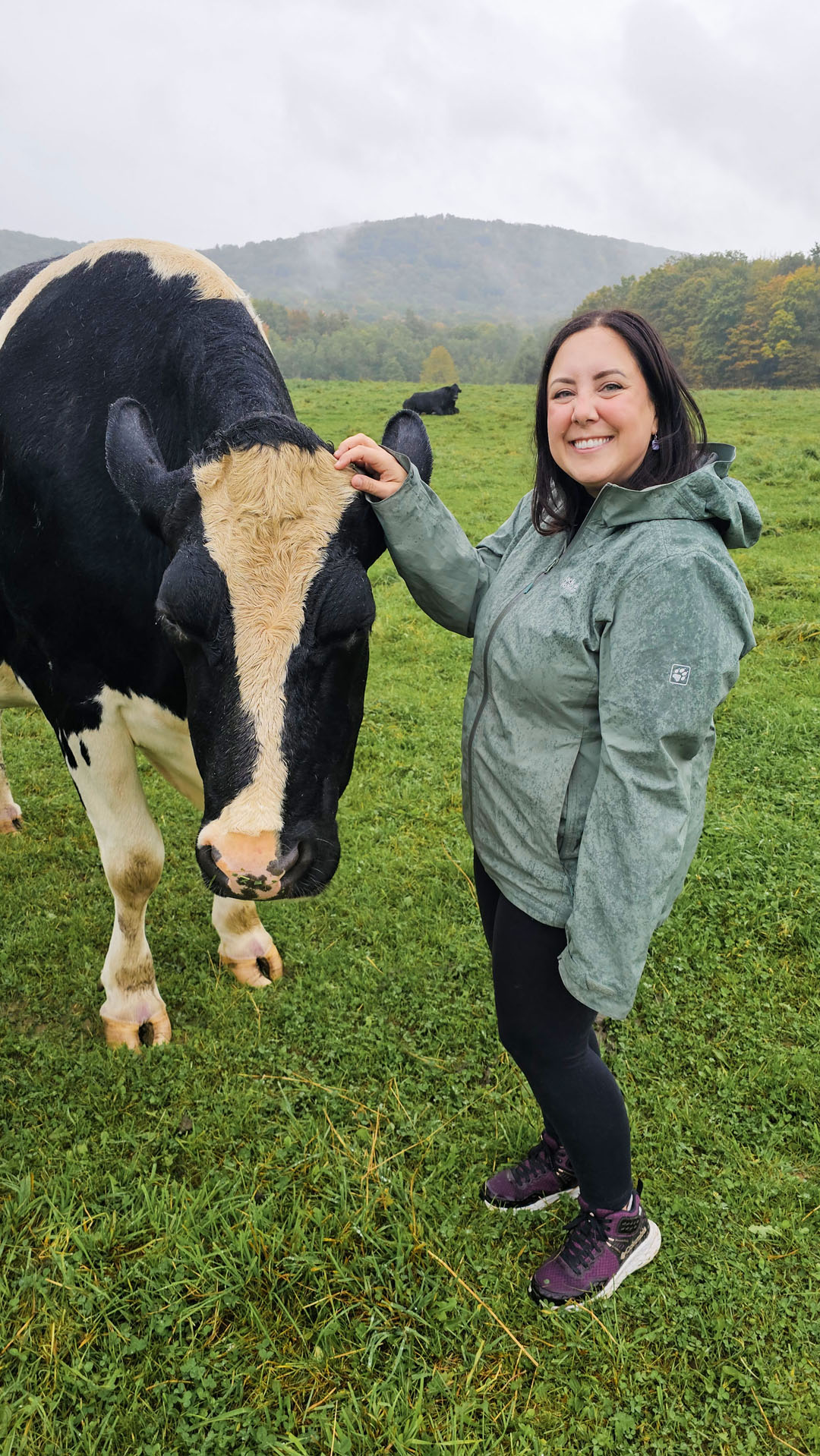 Lauren with a cow at Farm Sanctuary